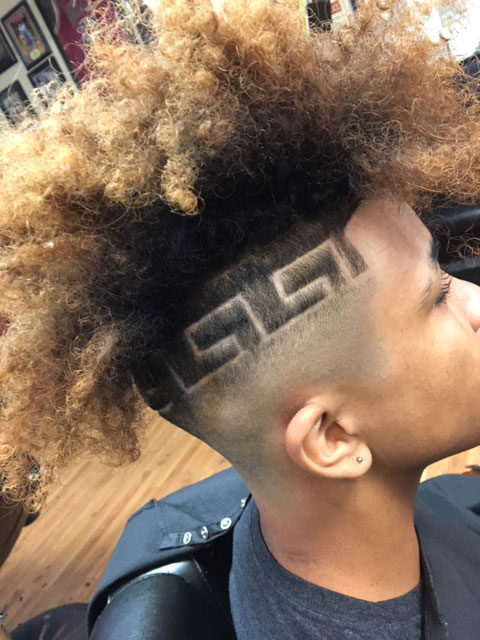 Blonde curly mohawk with Versace-style hair art