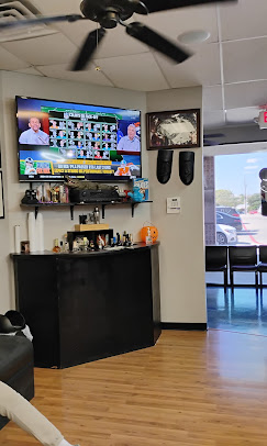 Interior of Blades & Shears barbershop with classic barber pole and lounge